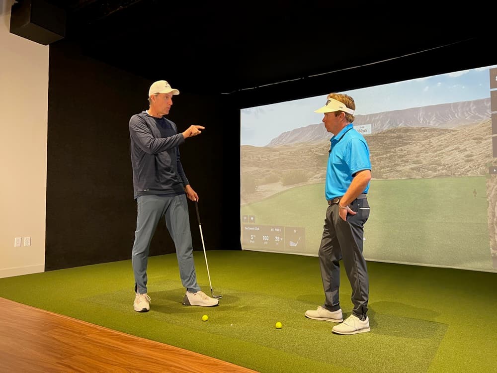 Coaching a golfer in a TrackMan simulator bay
